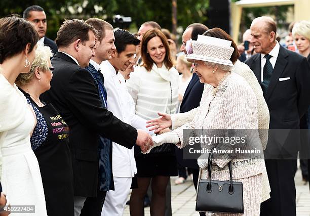 Queen Elizabeth ll and French President Francois Hollande meet wellwishers at the Marche aux Fleurs et aux Oiseaux on June 7, 2014 in Paris, France.