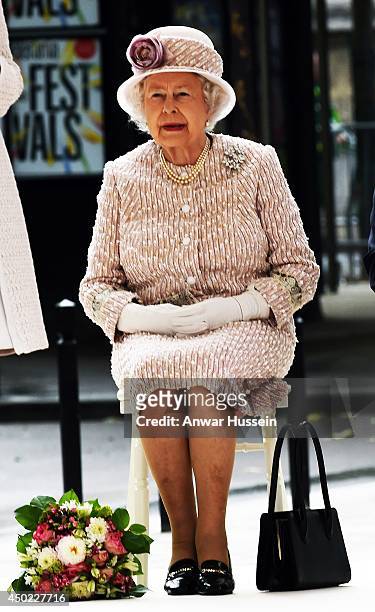 Queen Elizabeth ll sits to listen to a speech as she visits the Marche aux Fleurs et aux Oiseaux on June 7, 2014 in Paris, France.