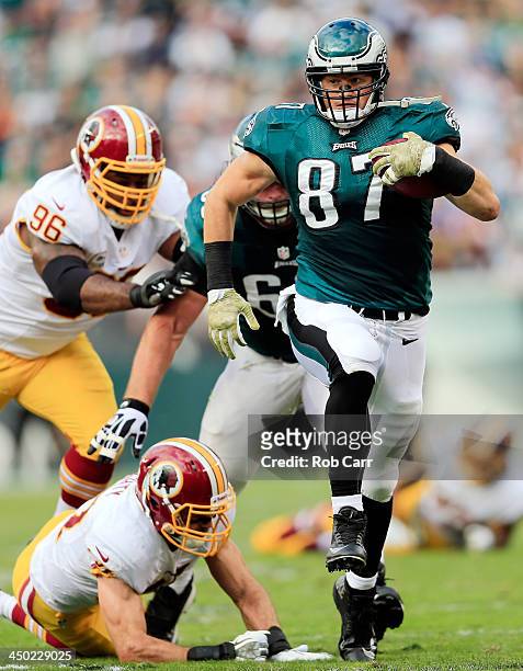 Strong safety Reed Doughty of the Washington Redskins tackles tight end Brent Celek of the Philadelphia Eagles after catching a second quarter pass...