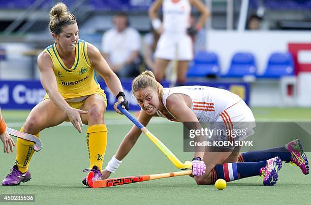 Australia's Kellie White and Netherland's Maartje Paumen play during a stage match in the women's tournament of the Field Hockey World Cup in The...