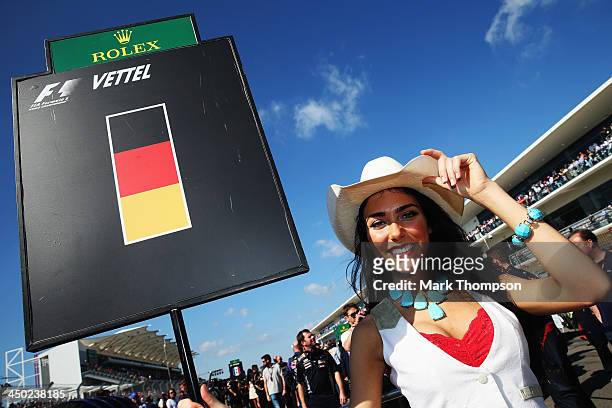 Grid girl for Sebastian Vettel of Germany and Infiniti Red Bull Racing is seen before the United States Formula One Grand Prix at Circuit of The...