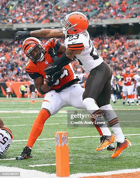 Jermaine Gresham of the Cincinnati Bengals runs for a touchdown while defended by Joe Haden of the Cleveland Browns during the game at Paul Brown...