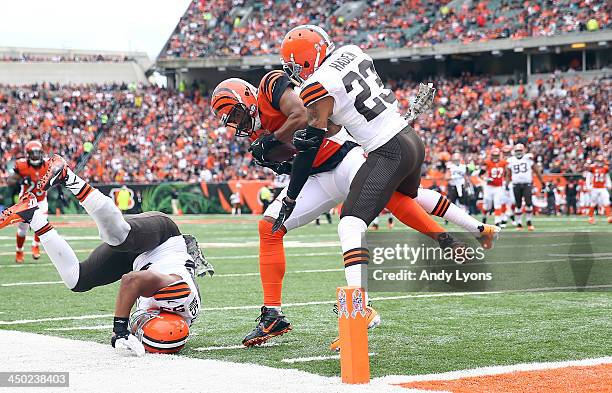 Jermaine Gresham of the Cincinnati Bengals runs for a touchdown while defended by Joe Haden of the Cleveland Browns during the game at Paul Brown...