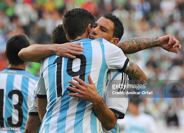 Ricardo Alvarez, of Argentina celebrates with teammate Maximiliano Lopez after scoring the first goal of his team of Argentina during a FIFA friendly...