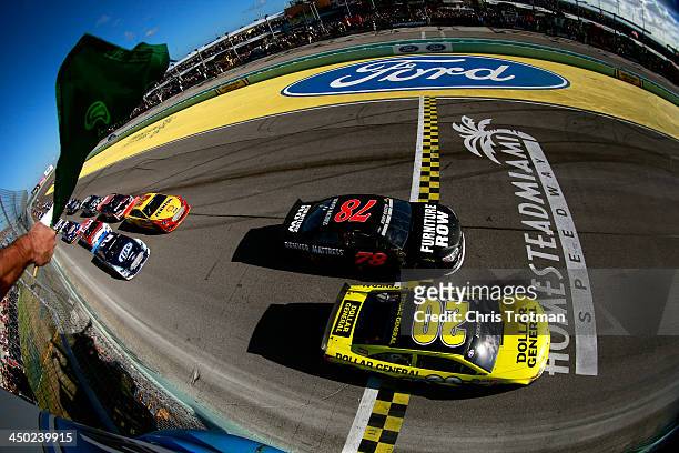 Matt Kenseth, driver of the Dollar General Toyota, and Kurt Busch, driver of the Furniture Row Chevrolet, lead the field to the green flag to start...