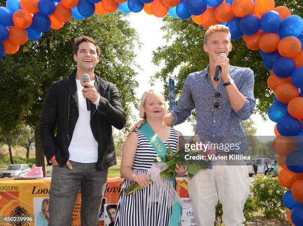 Actor Brant Daugherty and singer Cody Simpson present actress Lauren Potter with flowers at the New Horizons 5K Run/Walk on June 7, 2014 in Los...