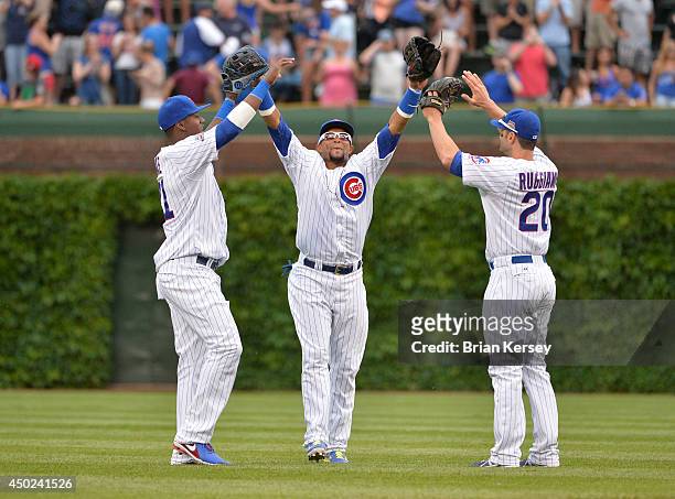 Junior Lake , Emilio Bonifacio and Justin Ruggiano of the Chicago Cubs celebrate their win over the Miami Marlins at Wrigley Field June 7, 2014 in...