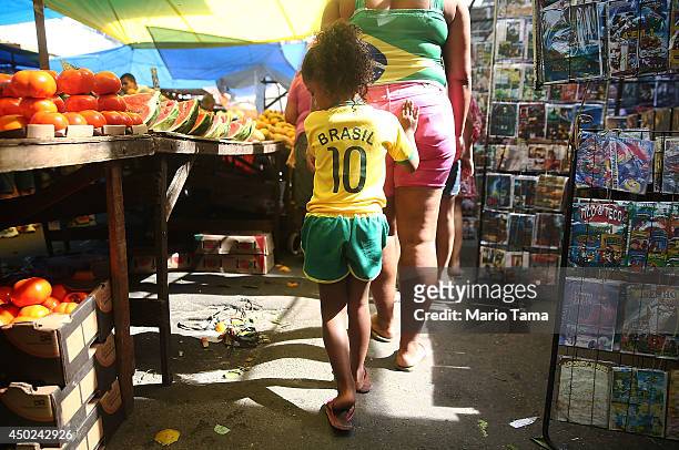 Girl walks in a Brazilian soccer jersey in the occupied Complexo da Mare, one of the city's largest 'favela' complexes, on June 7, 2014 in Rio de...