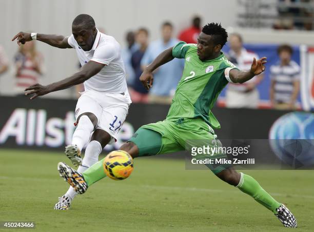 Forward Jozy Altidore of the United States shoots and scores his second game of the game behind defender Joseph Yobo of Nigeria during the...