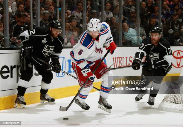 Anton Stralman of the New York Rangers tries to keep the puck away from Marian Gaborik and Jeff Carter of the Los Angeles Kings during the second...
