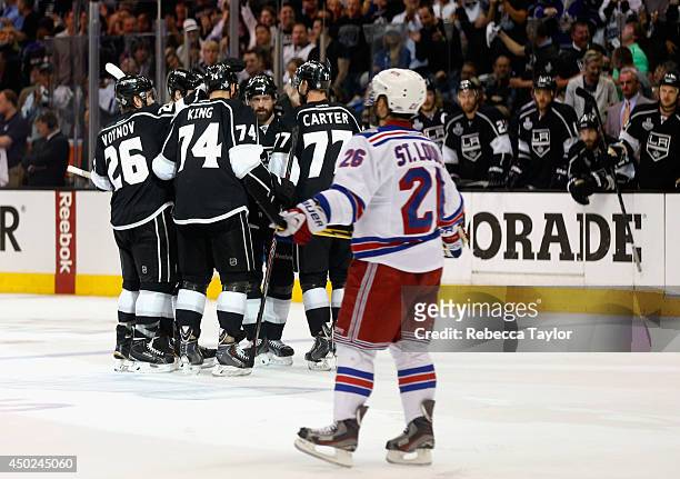 Justin Williams, Jeff Carter, Slava Voynov, Dwight King and Jarret Stoll of the Los Angeles Kings celebrate a goal scored by teammate Willie Mitchell...