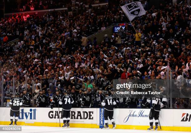 Justin Williams, Jeff Carter, Slava Voynov, Dwight King of the Los Angeles Kings celebrate a goal scored by teammate Willie Mitchell in the second...