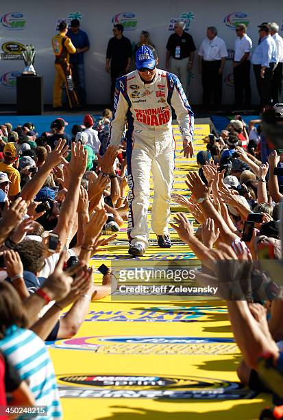 Dale Earnhardt Jr., driver of the National Guard Chevrolet, greets fans during the NASCAR Sprint Cup Series Ford EcoBoost 400 at Homestead-Miami...