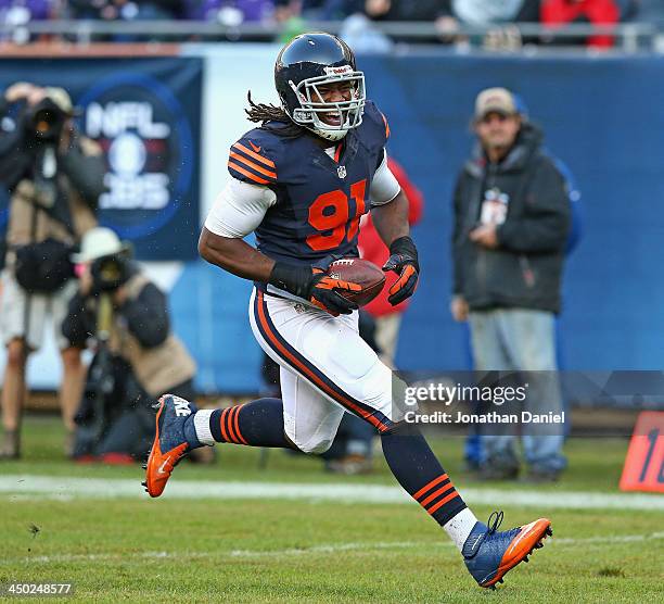 David Bass of the Chicago Bears smiles as he returns an interception for a touchdown against the Baltimore Ravens at Soldier Field on November 17,...