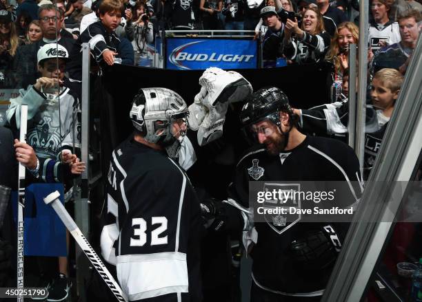 Justin Williams of the Los Angeles Kings congratulates goaltender Jonathan Quick after the Kings defeated the New York Rangers 5-4 with an overtime...