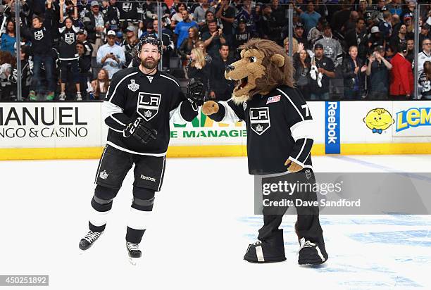 Justin Williams of the Los Angeles Kings gives a fist pump to mascot Bailey after the Kings defeated the New York Rangers 5-4 with an overtime goal...