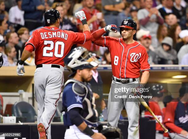 Ian Desmond of the Washington Nationals is congratulated by Danny Espinosa after he hit a two-run home run during the seventh inning of a baseball...