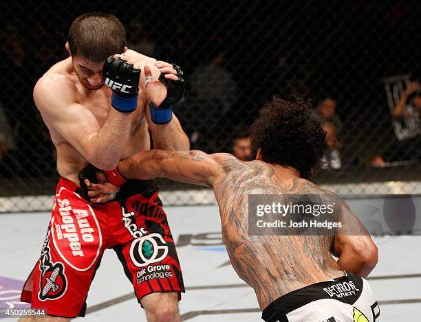 Benson Henderson punches Rustam Khabilov in their lightweight fight during the UFC Fight Night event at Tingley Coliseum on June 7, 2014 in...