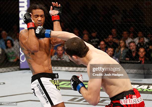 Rustam Khabilov punches Benson Henderson in their lightweight fight during the UFC Fight Night event at Tingley Coliseum on June 7, 2014 in...