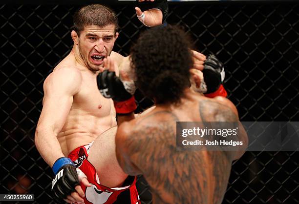 Rustam Khabilov kicks Benson Henderson in their lightweight fight during the UFC Fight Night event at Tingley Coliseum on June 7, 2014 in...