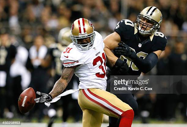 Donte Whitner of the San Francisco 49ers nearly picks off this reception intended for Jimmy Graham of the New Orleans Saints at Mercedes-Benz...