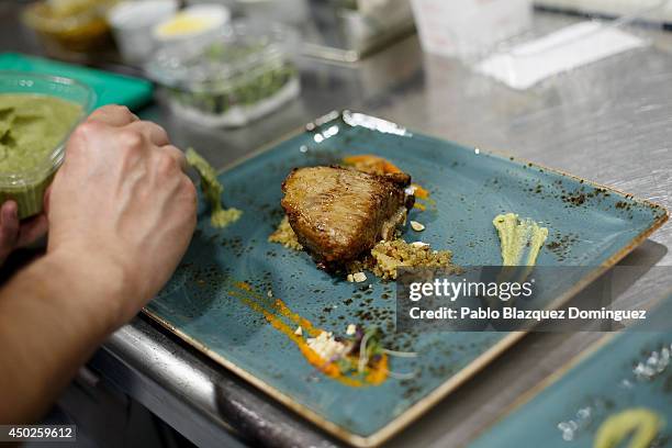 Cook prepares a red tuna dish inside El Campero Restaurant during the end of the Almadraba tuna fishing season on June 3, 2014 in Barbate, Cadiz...