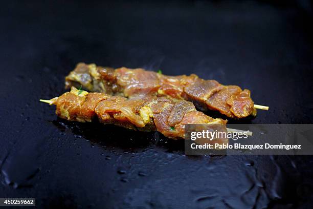 Pieces of red tuna are cooked on a griddle inside El Campero Restaurant during the end of the Almadraba tuna fishing season on June 3, 2014 in...