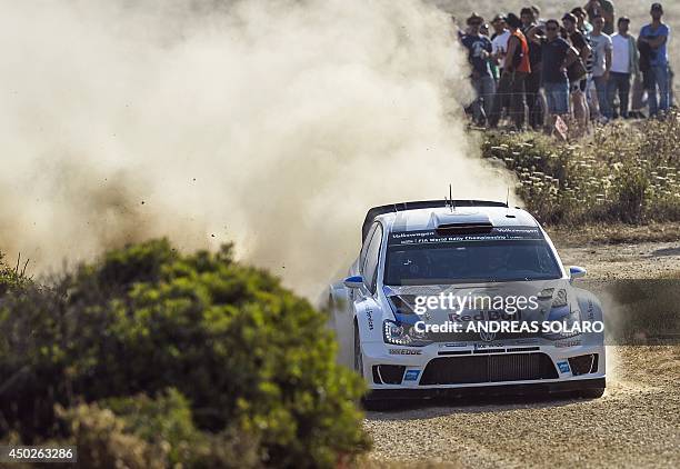 French driver Sebastien Ogier and his compatriot co-driver Julien Ingrassia steer their Volkswagen Polo R WRC as they compete during the fourteenth...