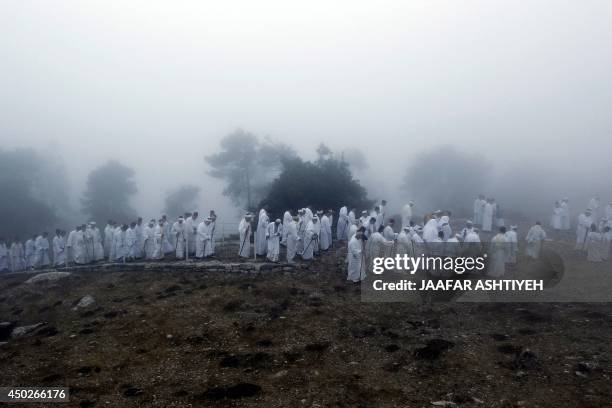 Samaritans pray on top of Mount Gerizim near the northern West Bank city of Nablus as they celebrate the Shavuot festival at dawn, on June 8, 2014....