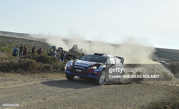 Polish driver Robert Kubica with his compatriot co-pilot Maciej Szczepaniak steer their Ford Fiesta RS WRC as they compete during the fourteenth...