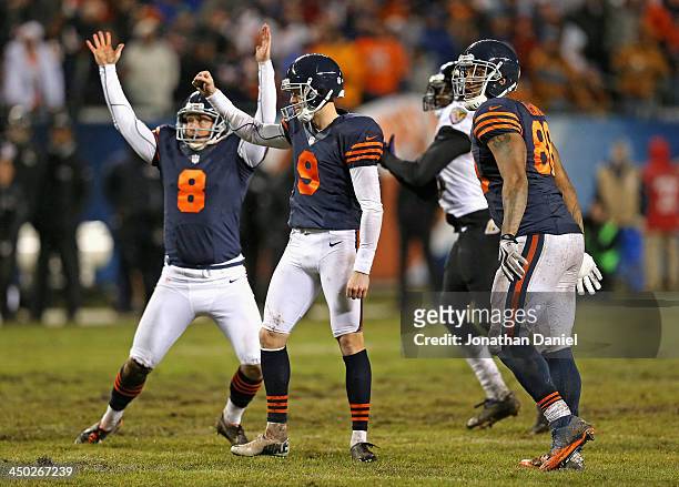 Adam Podlesh, Robbie Gould and Martellus Bennett of the Chicago Bears celebrate Gould's game-winning 38 yard field goal against the Baltimore Ravens...
