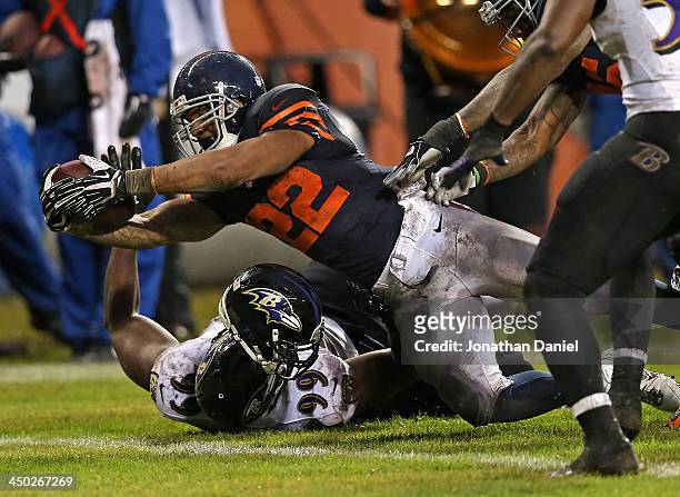 Matt Forte of the Chicago Bears dives over Chris Canty of the Baltimore Ravens to score a touchdown at Soldier Field on November 17, 2013 in Chicago,...
