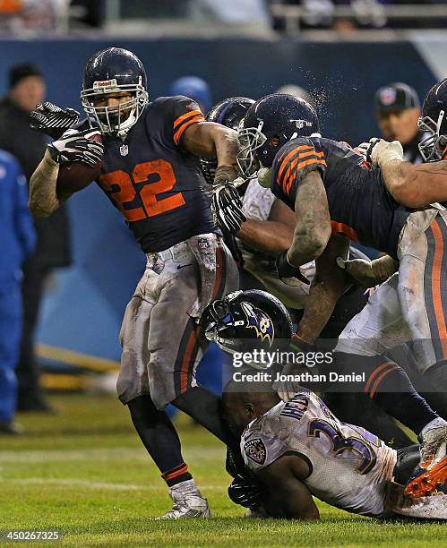 Matt Forte of the Chicago Bears runs for a touchdown as James Ihedigbo of the Baltimore Ravens looses his helmet trying to make the tackle at Soldier...