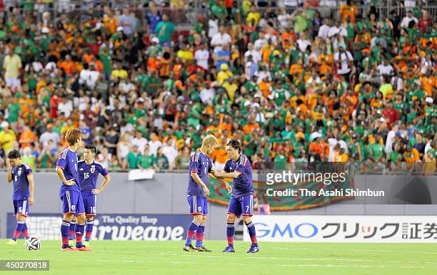 Yasuhito Endo passes the captain's armband to Keisuke Honda during the international friendly match between Japan and Zambia at Raymond James Stadium...
