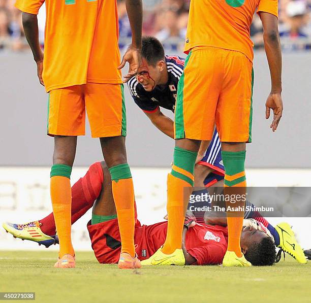 Shinji Okazaki of Japan gets injured after colliding with Toaster Nsabata of Zambia during the international friendly match between Japan and Zambia...