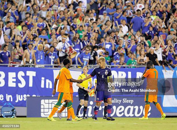 Keisuke Honda of Japan shakes hands with Zambia players after the international friendly match between Japan and Zambia at Raymond James Stadium on...