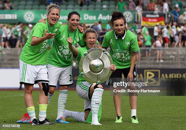 Laura Vetterlein, Selina Wagner, Josephine Henning and Lina Magull of VfL Wolfsburg celebrate with the trophy after the Women's Bundesliga match...