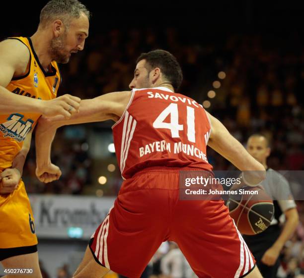 Boris Savovic of Muenchen fights for the ball with Sven Schultze of Berlin during the Beko BBL Playoff Final Game 1 between FC Bayern Muenchen and...