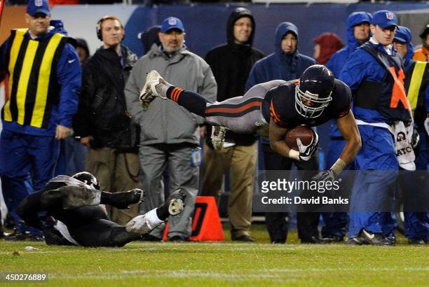 Matt Forte of the Chicago Bears dives over Matt Elam of the Baltimore Ravens during the fourth quarter on November 17, 2013 at Soldier Field in...