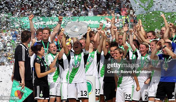 Captain Nadine Kessler of VfL Wolfsburg lifts the trophy in celebration alongsaide team mates after the Women's Bundesliga match between VfL...