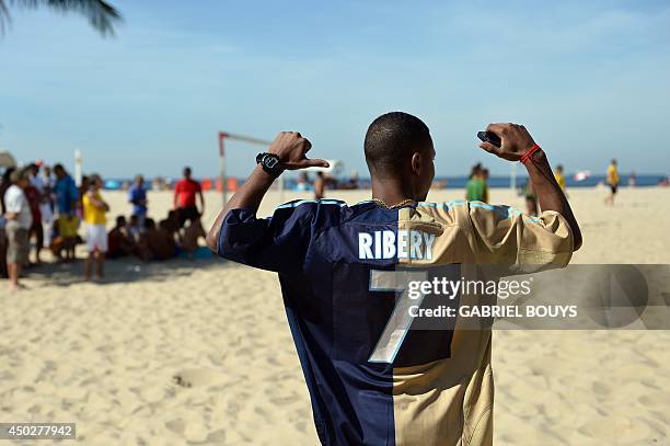 Man wearing the soccer jersey of France's Franck Ribery reacts during a beach football game in Copacabana beach, Rio de Janeiro, Brazil on June 8 a...