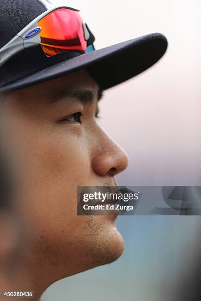 Masahiro Tanaka of the New York Yankees ponders a reporter's question as he talks members of the media during batting practice prior to a game to...
