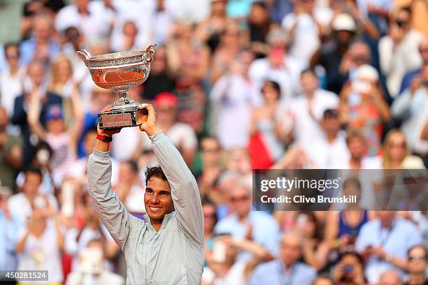 Rafael Nadal of Spain celebrates with the Coupe de Mousquetaires after victory in his men's singles final match against Novak Djokovic of Serbia on...