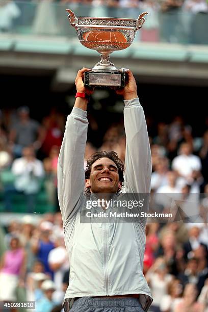 Rafael Nadal of Spain lifts the Coupe de Mousquetaires after victory in his men's singles final match against Novak Djokovic of Serbia on day fifteen...