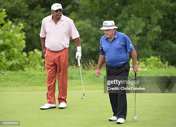 Jim Thorpe and Jim Colbert walk off the the 3rd green while competing in the final round of the Legends division of the Big Cedar Lodge Legends of...