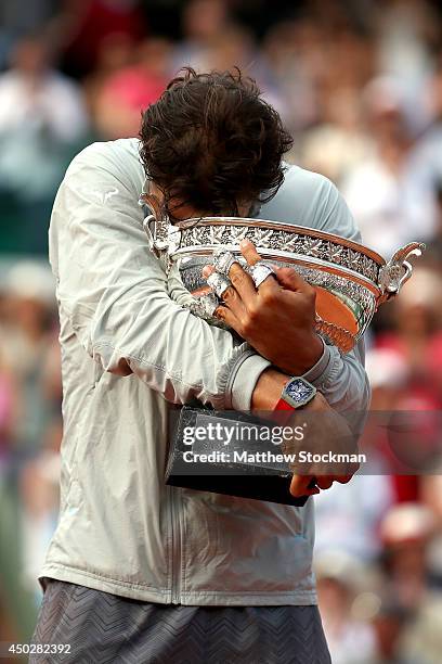 Rafael Nadal of Spain cries as he celebrates with the Coupe de Mousquetaires after victory in his men's singles final match against Novak Djokovic of...