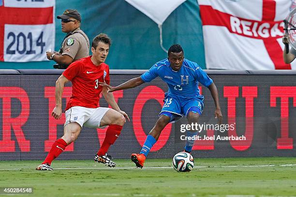 Leighton Baines of England and Marvin Chavez of Honduras chase a loose ball on June 7, 2014 during an International friendly match at SunLife Stadium...