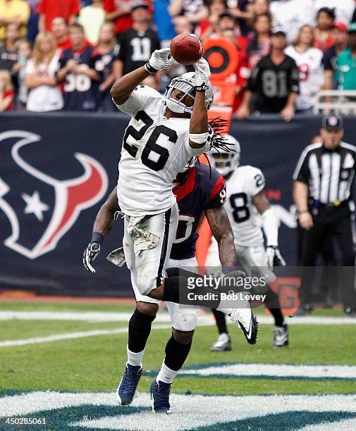 Usama Young of the Oakland Raiders has the ball just go off his fingertips as he jumps the route run by Andre Johnson of the Houston Texans in the...
