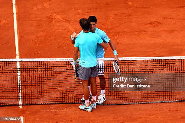 Rafael Nadal of Spain shakes hands with Novak Djokovic of Serbia after their men's singles final match on day fifteen of the French Open at Roland...