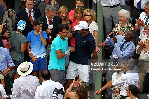 Rafael Nadal of Spain celebrates with his coach and uncle Toni Nadal after his men's singles final match against Novak Djokovic of Serbia on day...